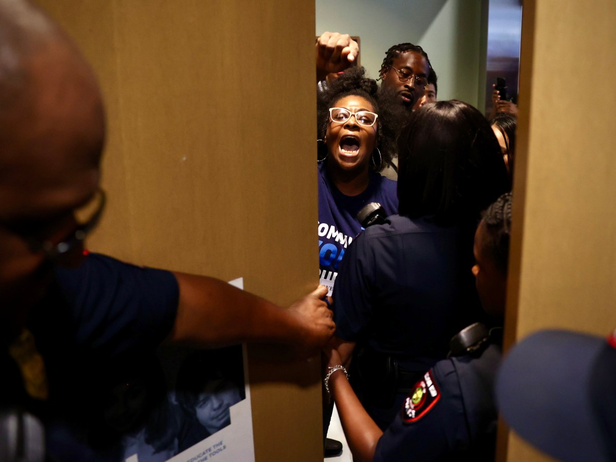Kourtney Revels protests at an HISD board meeting in Houston.