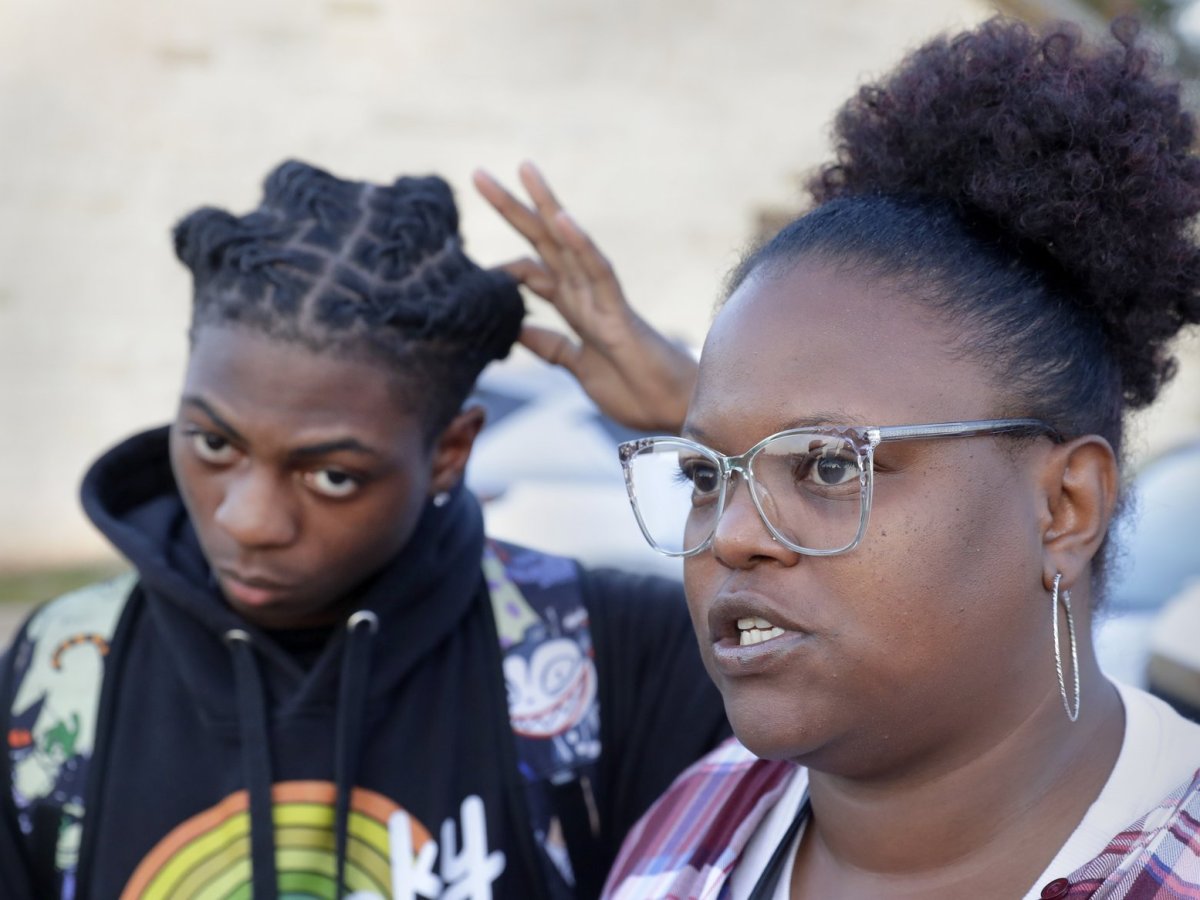 Darryl George, left, a 17-year-old junior, and his mother Darresha George, right, talk with reporters before walking across the street to go into Barbers Hill High School after Darryl served a 5-day in-school suspension for not cutting his hair Monday, Sept. 18, 2023, in Mont Belvieu.