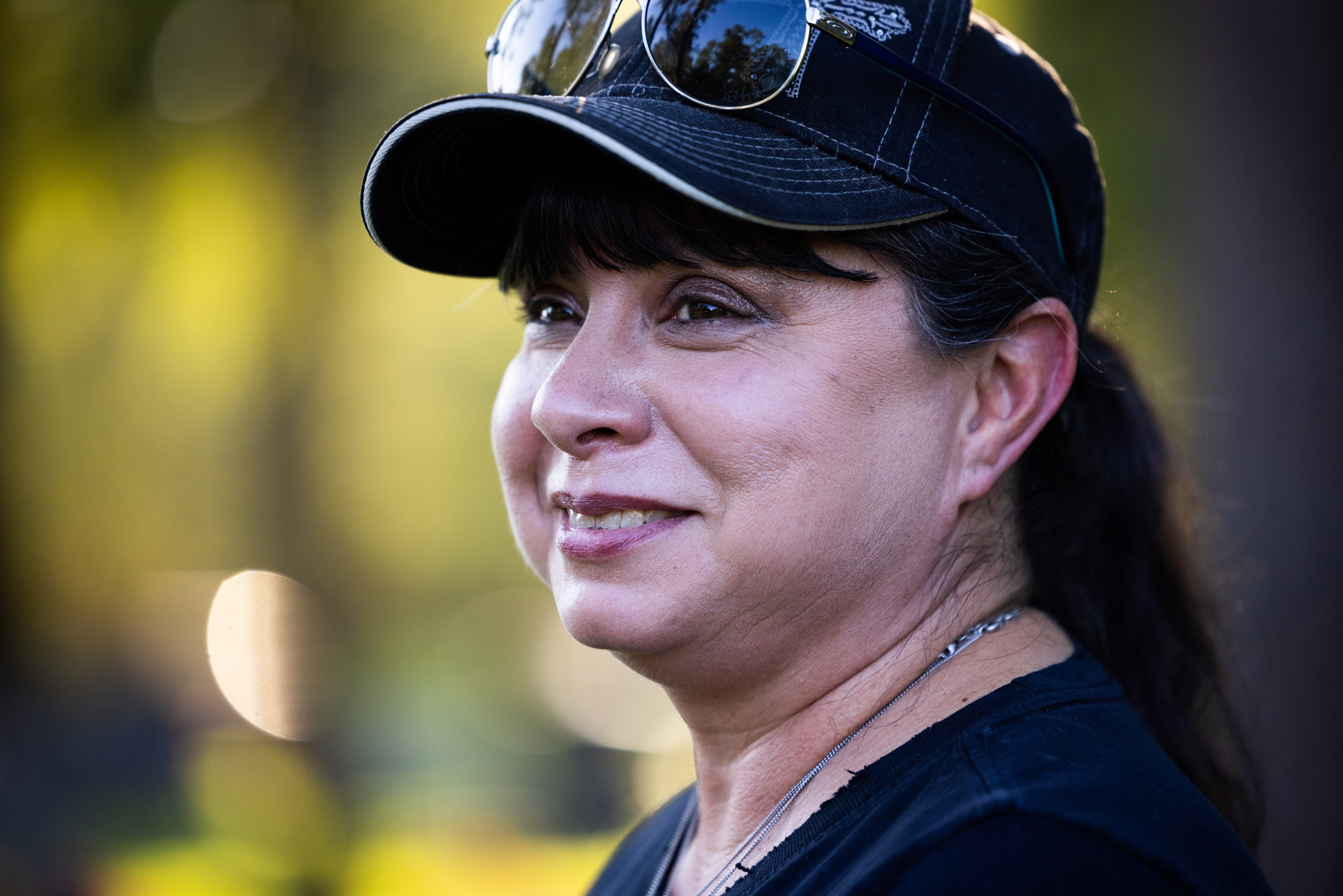 Lisa Klein observes her family during a visit to the grave site for her husband, Walt, and her daughter, Rebecca, who died three years apart. Walt died in 2018 following a heart attack in the Harris County Jail and Rebecca died of cervical cancer in 2021.