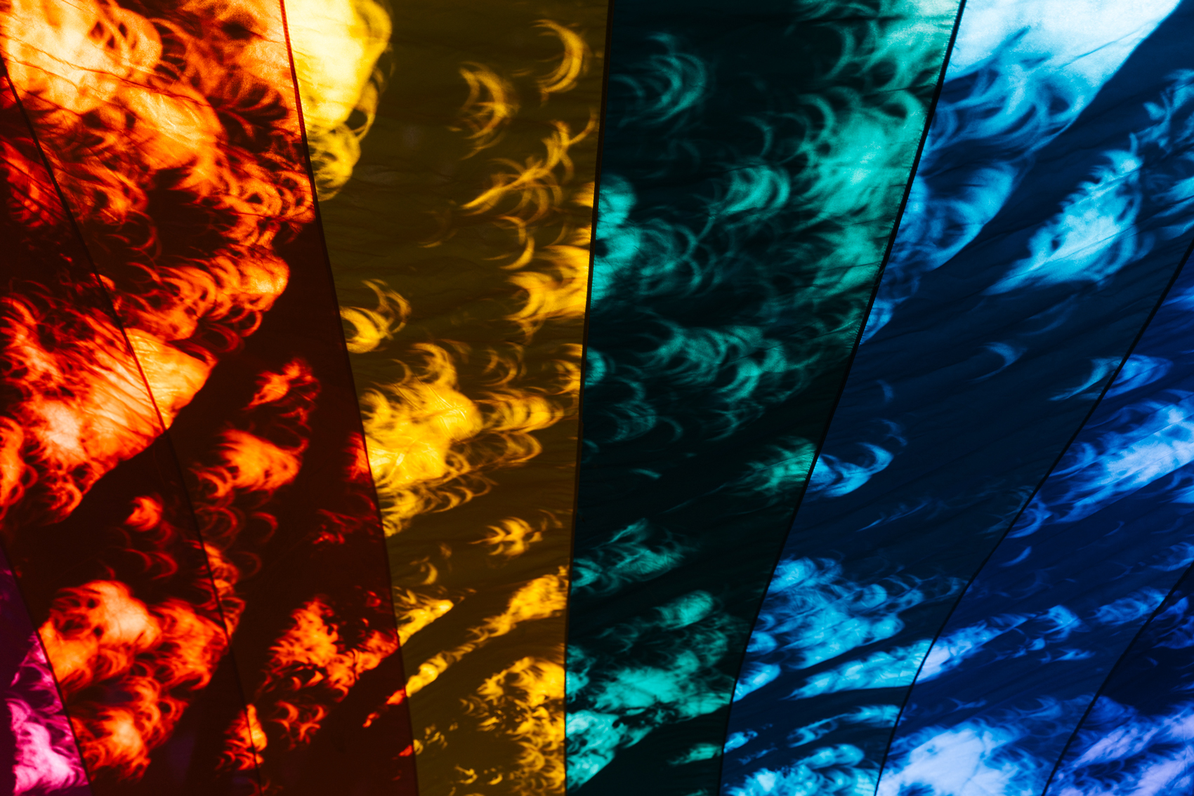 Festival attendees look at the solar eclipse using special glasses during Katy Pride festival at First Christian Church on Saturday, Oct. 14, 2023, in Katy. 
