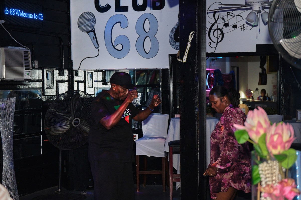 Rosalyn Jackson, right, owner of Club 68, a long-time gathering spot for the Black community in Galveston, dances with Darnell Durry