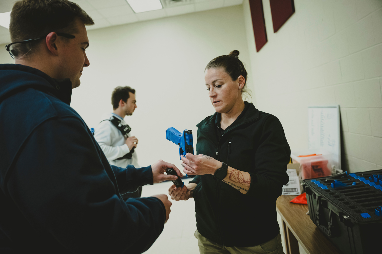 A trainer distributes Simunition guns to recently graduated Montgomery County sheriff’s deputies, before a training exercise for how to respond to a mass shooting, on November 28, 2023 in New Caney, Texas.