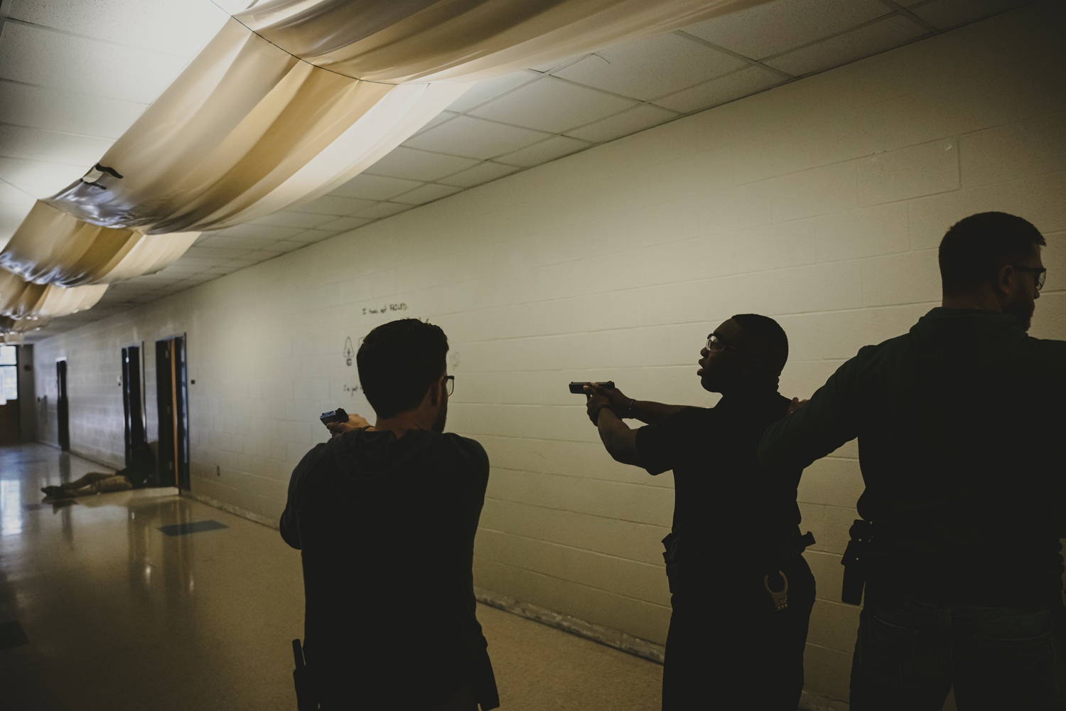 Recently graduated Montgomery County sheriff’s deputies enter a school hallway while training to respond to an active shooter, on Nov. 28, 2023 in New Caney, Texas.