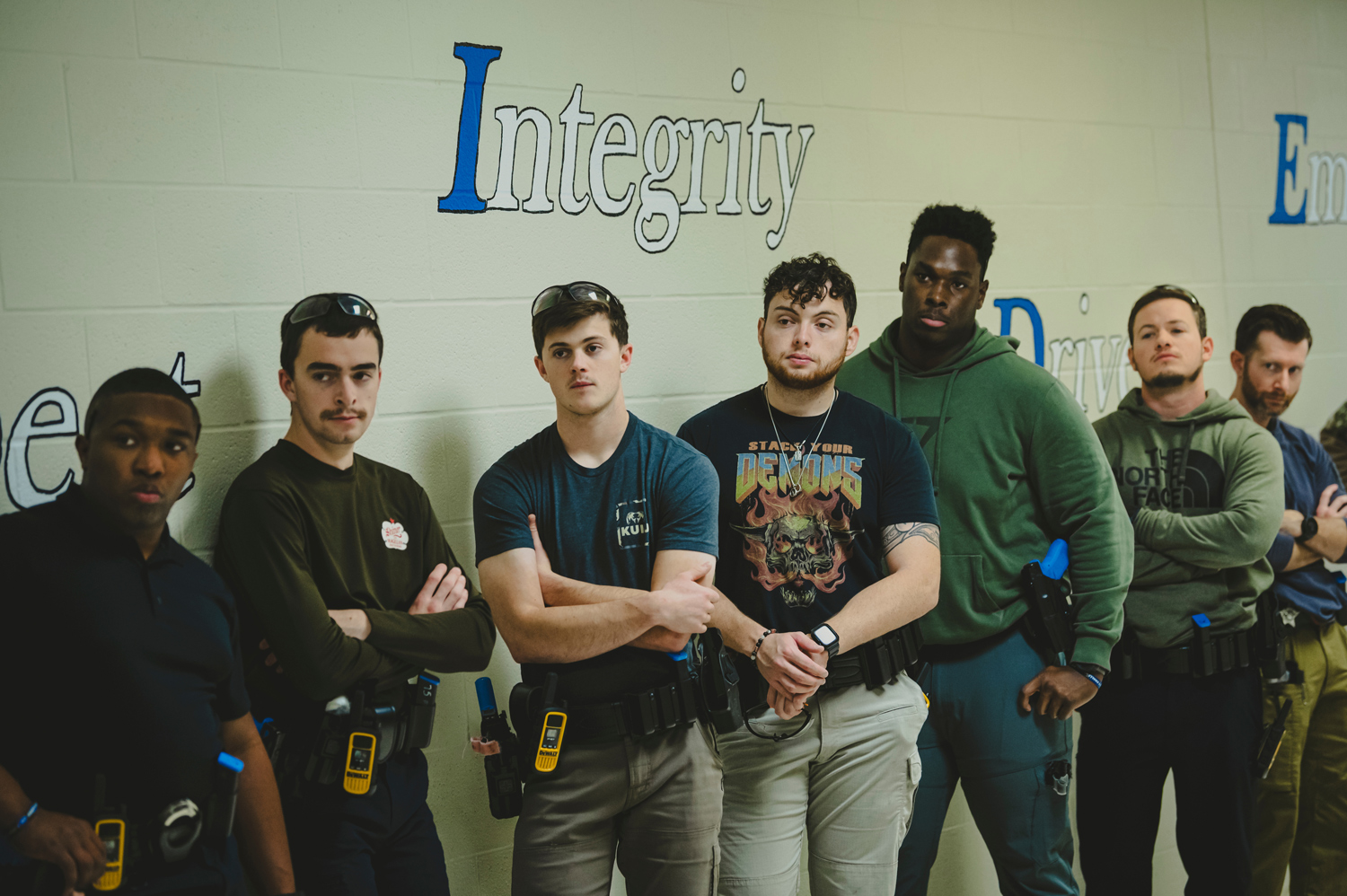 Recently graduated Montgomery County sheriff’s deputies listen as Specialist Landon Slatter debriefs them after a joint training exercise on how police and EMS should work together when responding to a mass shooting