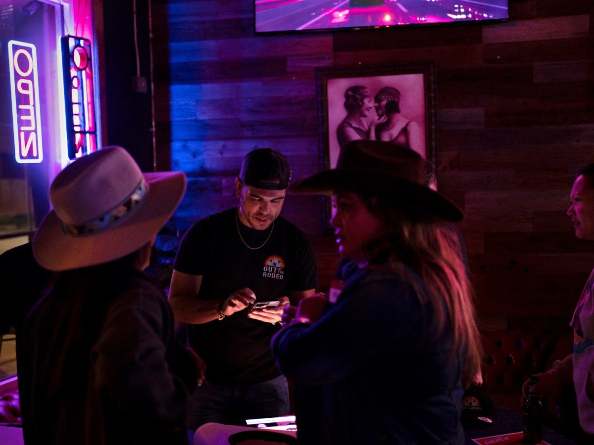 Anthony Ferrell, center, hosts a pop-up event for “Out at the Rodeo” at Pearl Bar, one of Houston's last-standing lesbian bars, to sell merchandise and raise awareness in preparation for their event on March 9 at the Houston Livestock Show and Rodeo.