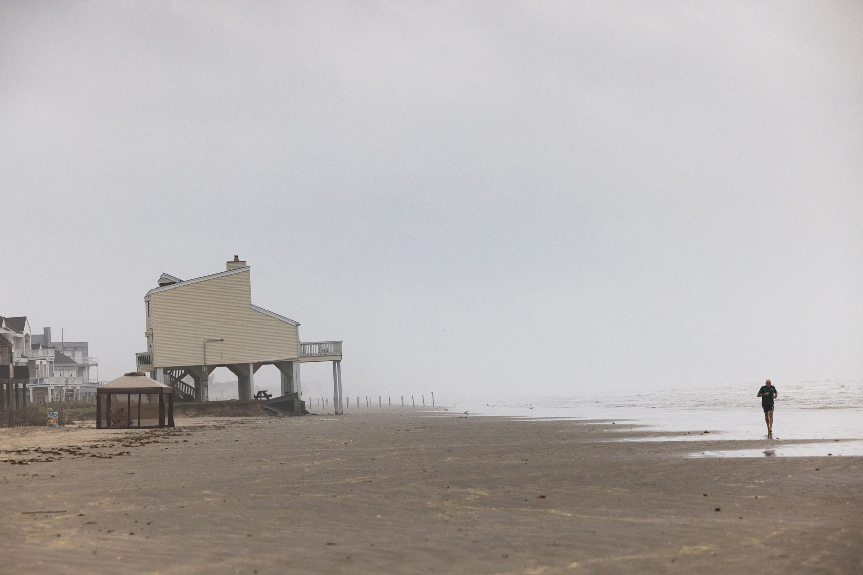 Jogger runs along the Galveston Beach shoreline.