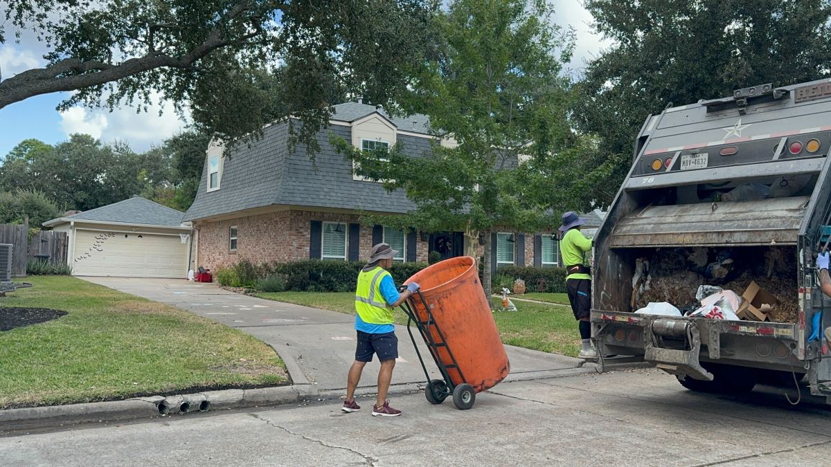 Texas Pride Disposal employees collect trash from homes in the Lakeside Estates neighborhood on Friday Oct. 25, 2024, in Houston.
