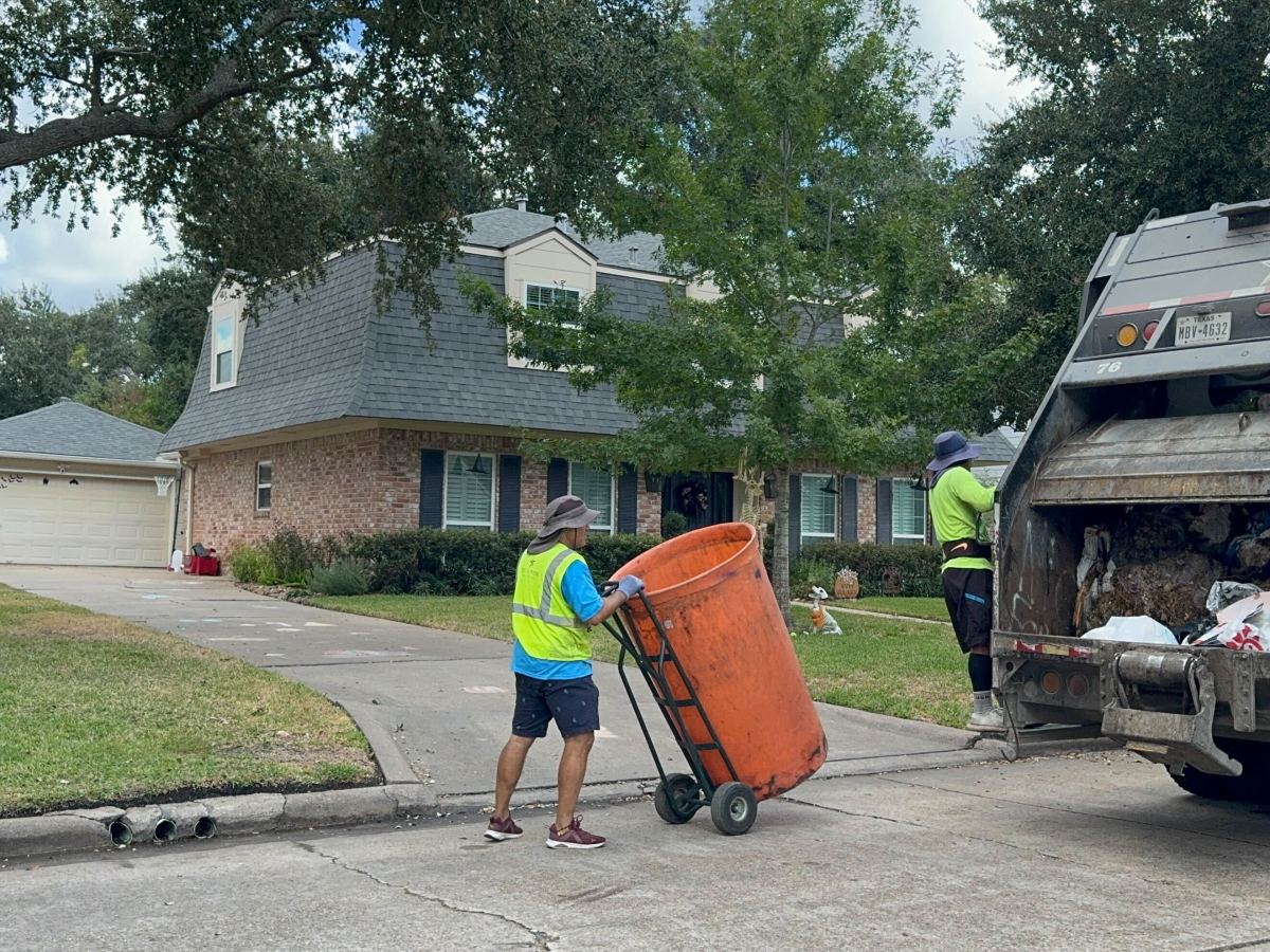 Texas Pride Disposal employees collect trash from homes in the Lakeside Estates neighborhood on Friday Oct. 25, 2024, in Houston.