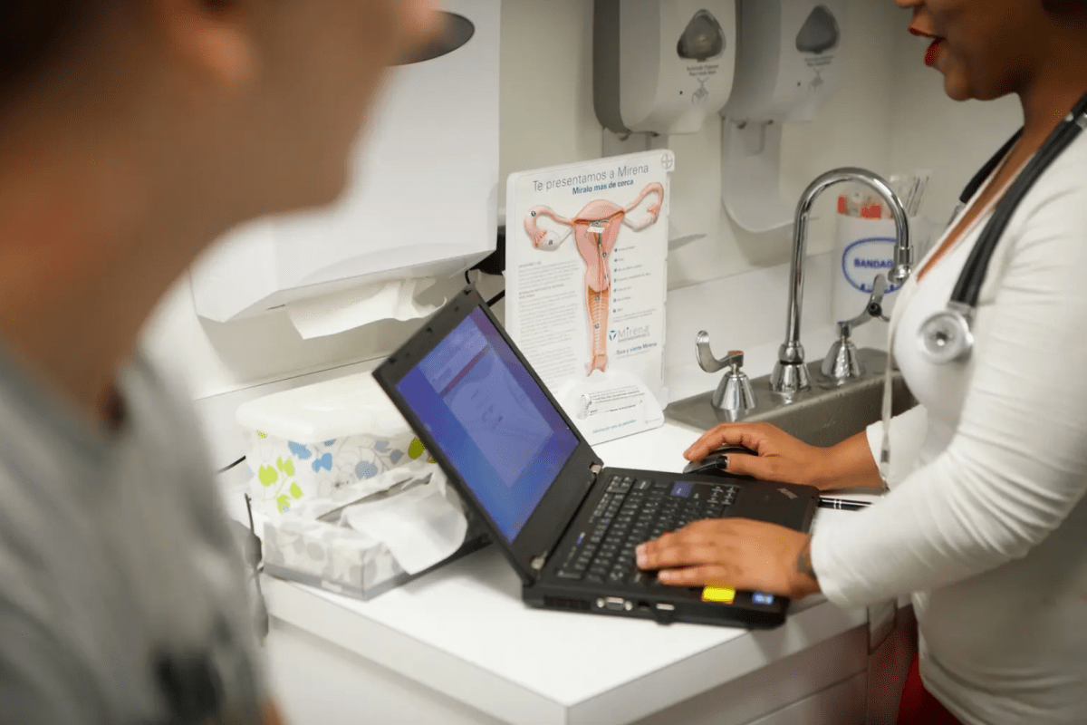 A nurse speaks with a patient at a clinic.